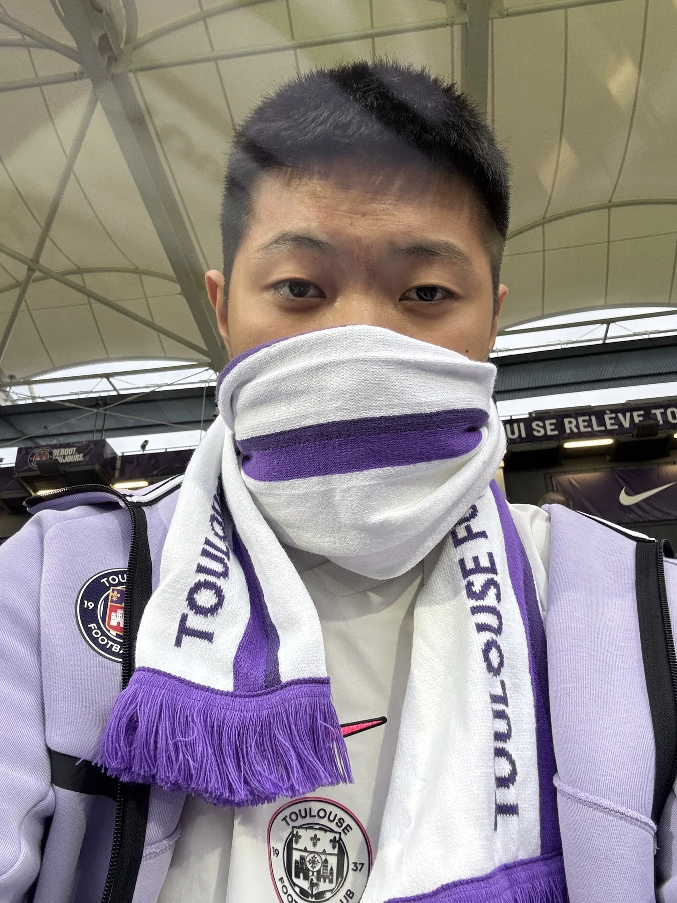 Wearing Toulouse FC purple at the stadium
